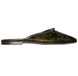 Joy Mule, a flat mule with an almond-shaped toe, small bow detail, and a green and black camouflage print.