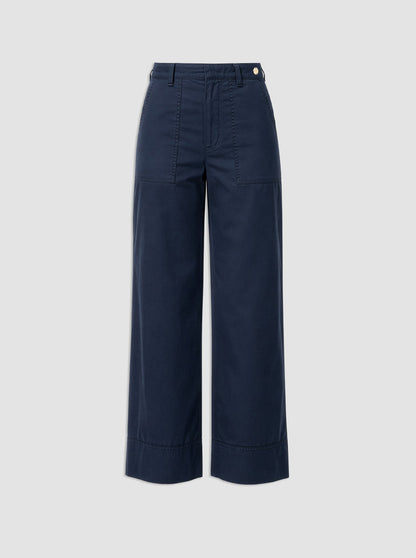 The Sailor Pant by Callas Milano is a navy blue cotton twill wide-leg style featuring front patch pockets, belt loops, and a button closure, shown against a plain light gray background.