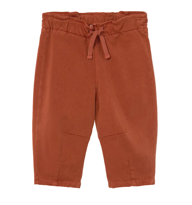 A pair of Cozmo Baby Saul Twill Pants in a rust color, featuring an elastic waistband and drawstring, displayed flat on a white background.