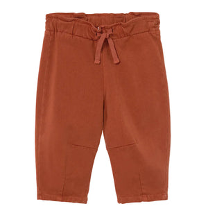 A pair of Cozmo Baby Saul Twill Pants in a rust color, featuring an elastic waistband and drawstring, displayed flat on a white background.