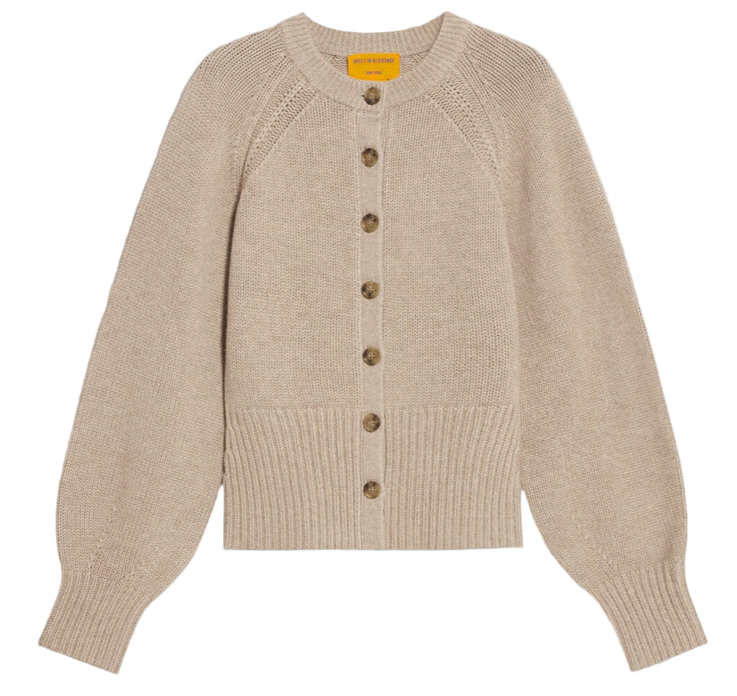 The Sculpted Cardigan by Guest in Residence is a beige cashmere sweater with long puffed sleeves, ribbed cuffs and hem, and a front button closure.