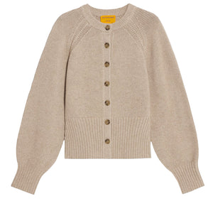The Sculpted Cardigan by Guest in Residence is a beige cashmere sweater with long puffed sleeves, ribbed cuffs and hem, and a front button closure.