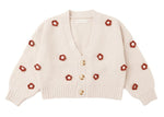 Cozy and cream-colored, the Rylee & Cru Baby Girls' and Girls' Boxy Crop Cardigan features a textured knit, V-neck, three buttons, bubbled sleeves, and scattered red floral patterns.