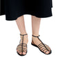 A person wearing a black skirt is shown with Proenza Schouler Tee Cage Flat Sandals, featuring T-crossed and ankle straps.