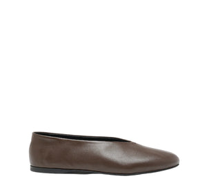 The Proenza Schouler Tee Ballet Flat is a brown Nappa leather slip-on with a rounded toe and black sole, shown in side profile against a white background.