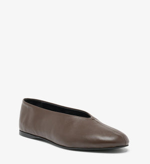 The Proenza Schouler Tee Ballet Flat features brown nappa leather, a rounded toe, and a thin black sole, shown against a white background.