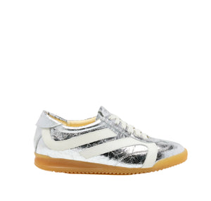 The Proenza Schouler Track Crinkled Metallic Sneakers feature silver metallic leather with white accents and laces, plus a light brown rubber sole, shown in profile against a white background.