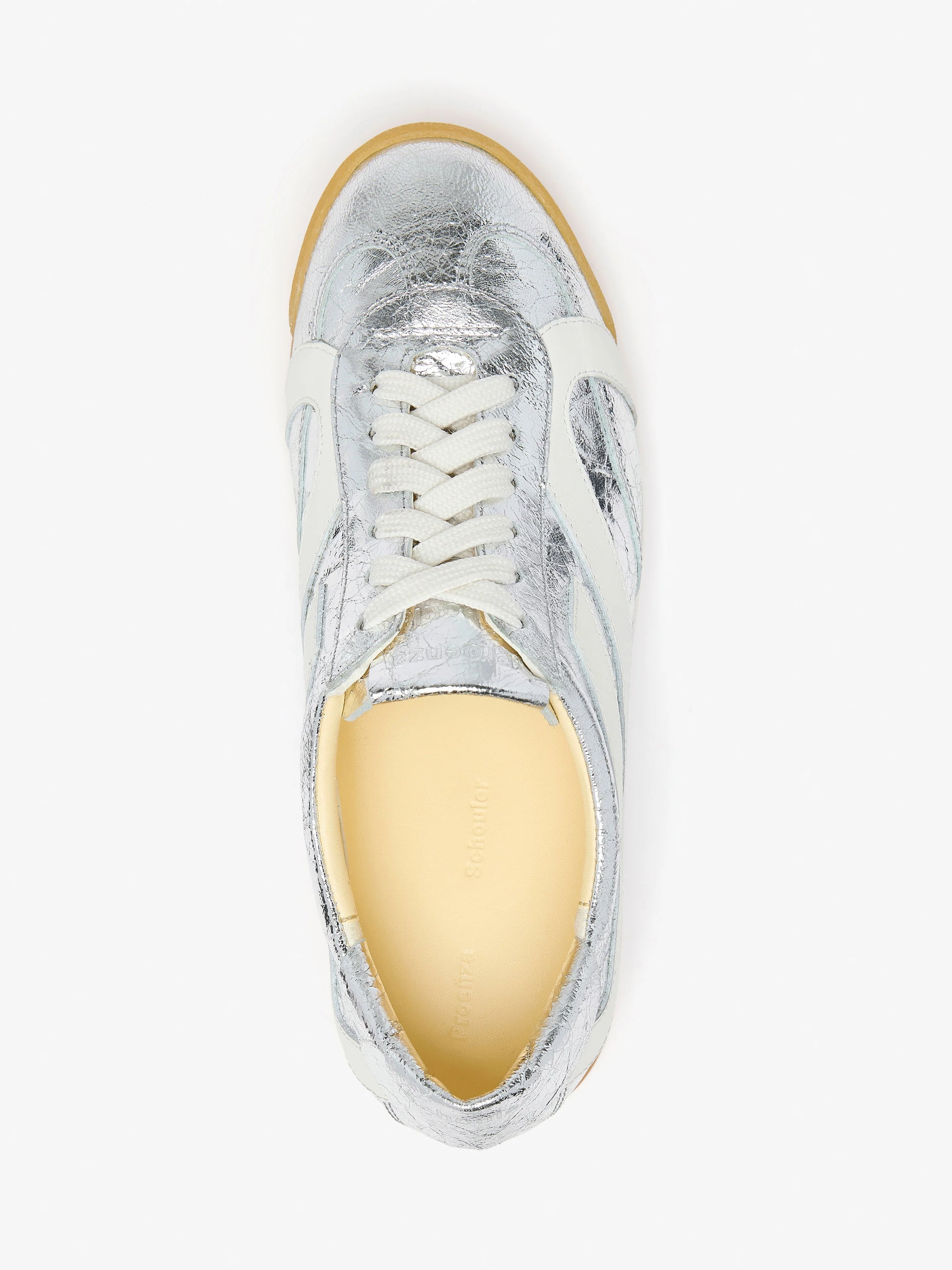 A top view of the Proenza Schouler Track Crinkled Metallic Sneakers features white laces, a memory foam insole, and a light tan sole, all photographed on a plain white background.