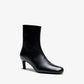 The Uma Ankle Boot by Proenza Schouler is a single black leather ankle boot featuring a rounded toe and a mid-height kitten heel, displayed on a white background.