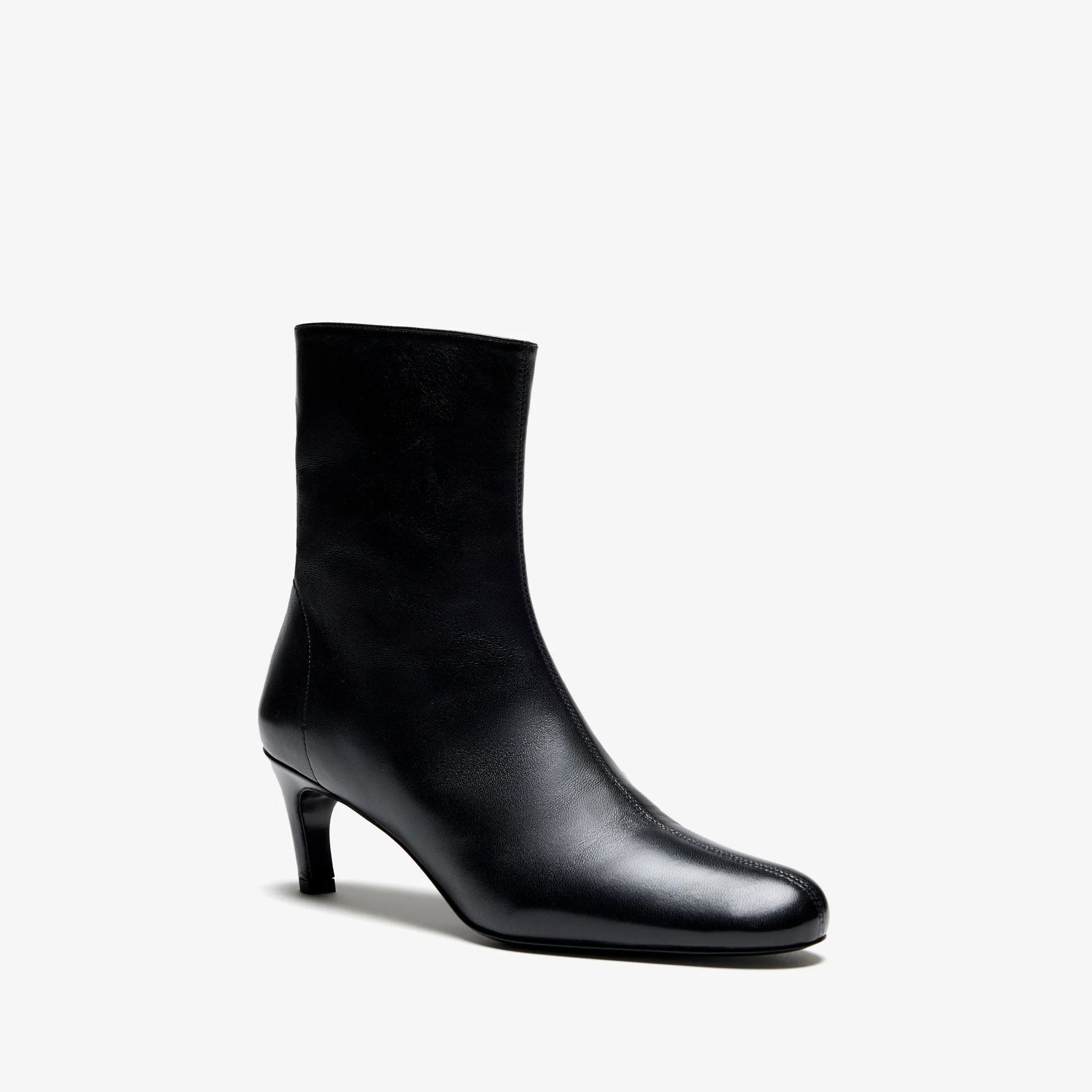 The Uma Ankle Boot by Proenza Schouler is a single black leather ankle boot featuring a rounded toe and a mid-height kitten heel, displayed on a white background.