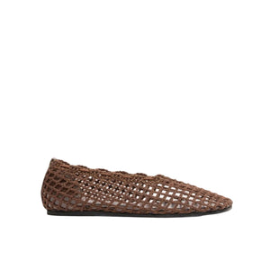 The Proenza Schouler Slant Crochet Flat is a brown slip-on shoe featuring a mesh-like, woven design and squared toe, shown in profile against a white background.