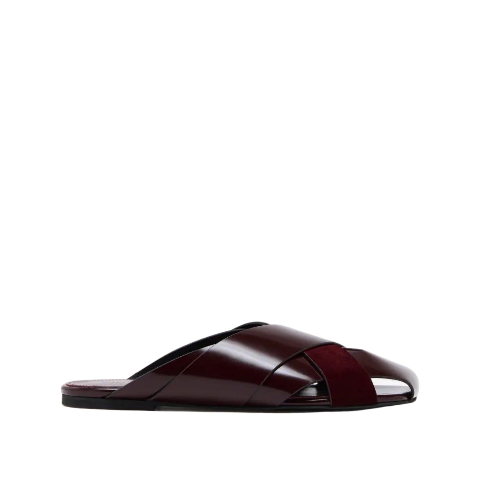 The Proenza Schouler Slant Cross Slides is a maroon leather sandal with crisscross straps and an open toe, crafted from brushed calf, shown on a white background.