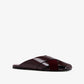 The Proenza Schouler Slant Cross Slides is a single burgundy sandal with wide crisscross brushed calf suede straps and a flat sole, displayed against a plain white background.