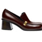 Proenza Schouler Esme Loafer in dark brown nappa latex, featuring a block heel and a gold-tone metal accent on the side.