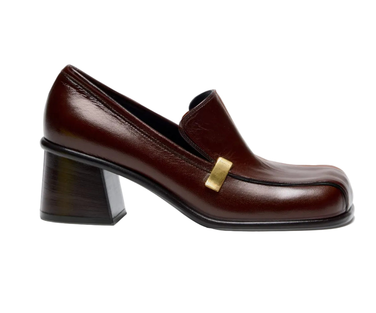 Proenza Schouler Esme Loafer in dark brown nappa latex, featuring a block heel and a gold-tone metal accent on the side.
