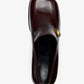 Top-down view of a dark brown Nappa Latex Proenza Schouler Esme Loafer with a square toe and a small gold metal plaque on the side.
