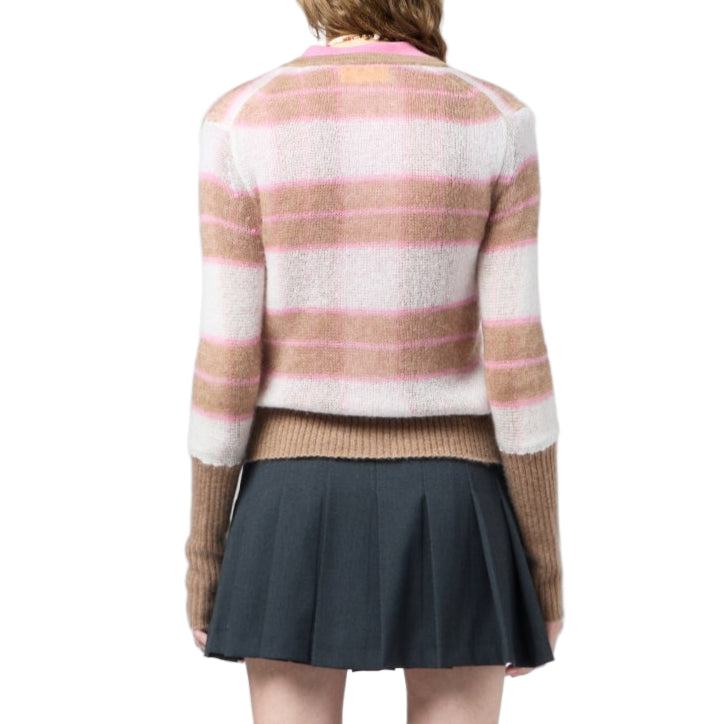 A person wearing the Guest in Residence Shadow Plaid Cardigan, featuring pink, white, and beige stripes, paired with a dark pleated skirt and shown from the back against a white background.
