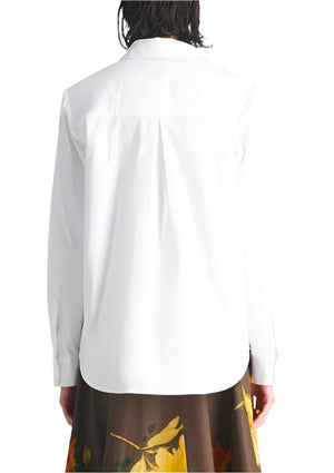 Someone wearing the Lela Rose Draped Rose Button Down Shirt in white cotton poplin with a brown skirt featuring yellow floral patterns, seen from the back.