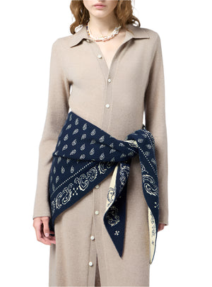 A woman wears the Showtime Cashmere Shirt Dress by Guest in Residence, styled with a navy paisley bandana at the waist and a pearl necklace.
