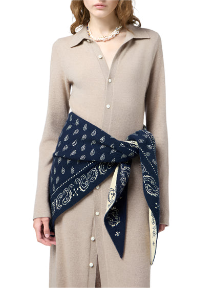 A woman wears the Showtime Cashmere Shirt Dress by Guest in Residence, styled with a navy paisley bandana at the waist and a pearl necklace.