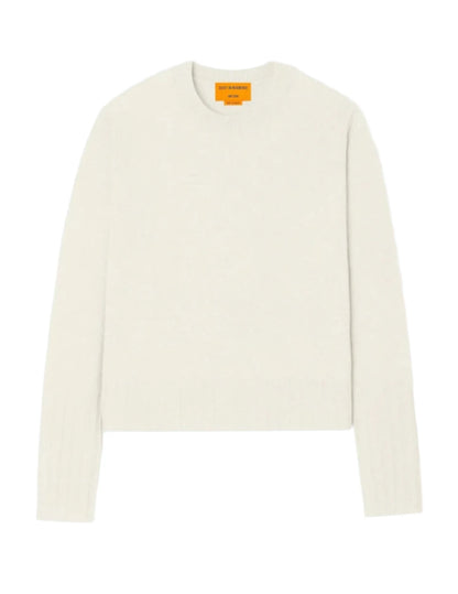 Guest in Residence's Shrunken Crew Cashmere Sweater is a white slim-fit long-sleeve knit with a round neckline and features a visible orange label on the inside collar.