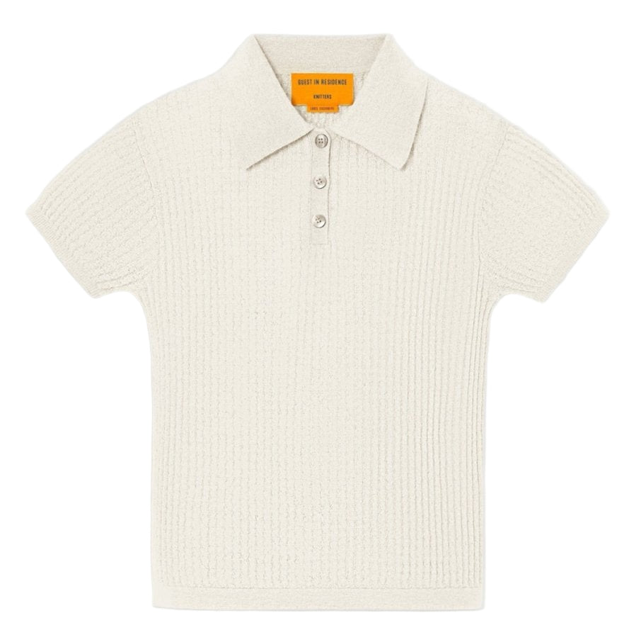 The Shrunken Cashmere Polo by Guest in Residence features short sleeves, a collared ribbed waffle knit in off-white, and a three-button placket, shown flat on a white background.