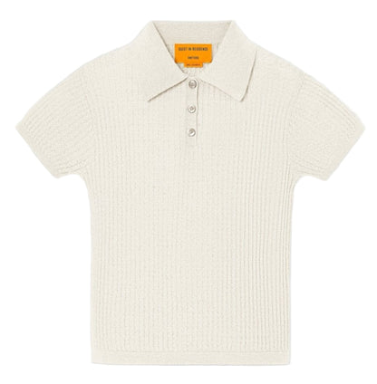 The Shrunken Cashmere Polo by Guest in Residence features short sleeves, a collared ribbed waffle knit in off-white, and a three-button placket, shown flat on a white background.