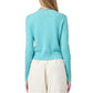 A person is shown from the back against a white background wearing Guest in Residence's Shrunken Crew Cashmere Sweater in light blue and high-waisted cream pants.