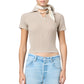 A person wearing the Guest in Residence Shrunken Cashmere Polo in beige, paired with light blue jeans, a light-colored neck scarf, and a beaded choker necklace.