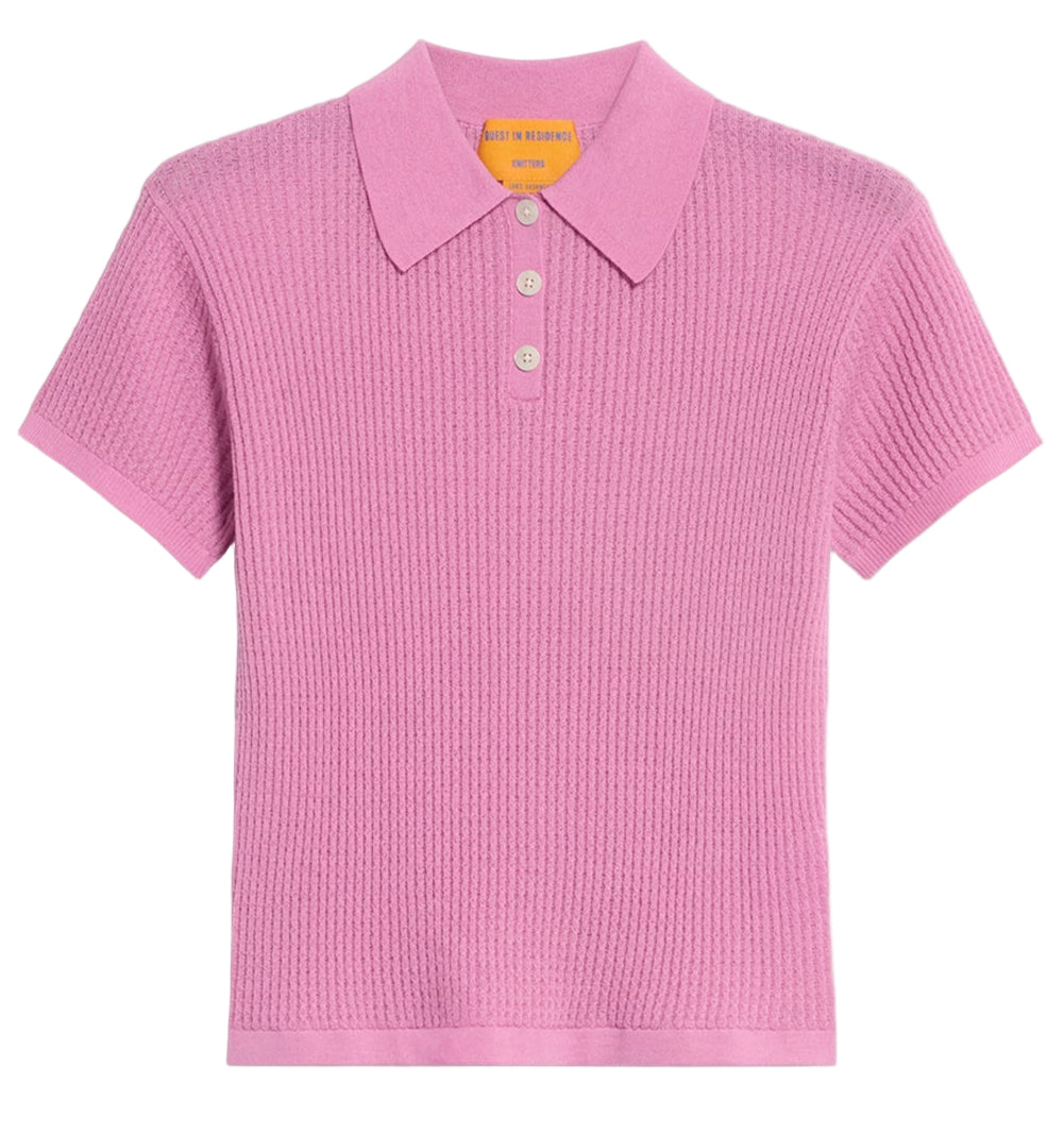 The Shrunken Cashmere Polo by Guest in Residence is a short-sleeve, light purple waffle knit shirt with a ribbed texture, three buttons, and a flat collar, shown on a plain white background.