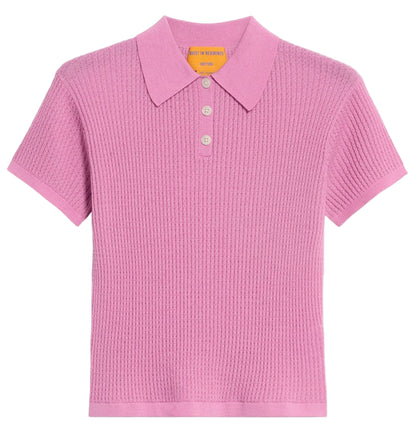 The Shrunken Cashmere Polo by Guest in Residence is a short-sleeve, light purple waffle knit shirt with a ribbed texture, three buttons, and a flat collar, shown on a plain white background.
