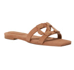 The Simkhai Monogram Suede Flat Slide features a tan geometric cutout strap, open toe, and low heel—an ideal casual staple. Shown on a white background.