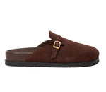 The Simkhai Adara Buckle Suede Slipper is a brown suede slide mule with an adjustable gold buckle, cushioned footbed, and black rubber sole, shown in side profile.
