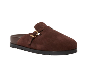 The Simkhai Adara Buckle Suede Slipper features a brown suede upper, closed toe, adjustable buckle, cushioned footbed, and black rubber sole.