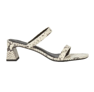 The Simkhai Clara Snake Block Heel features white and gray snakeskin-patterned double straps, a chunky textured leather block heel, and a squared toe, shown in side profile against a white background.