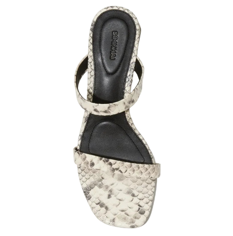 The Simkhai Clara Snake Block Heel is a women's sandal with textured leather block heels, a faux snakeskin pattern, black cushioned footbed, and two straps, shown from above.