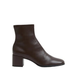 The Simkhai Bianca Stretch Leather Ankle Boot is a single dark brown ankle boot featuring a low block heel and rounded toe, shown from the side against a white background.