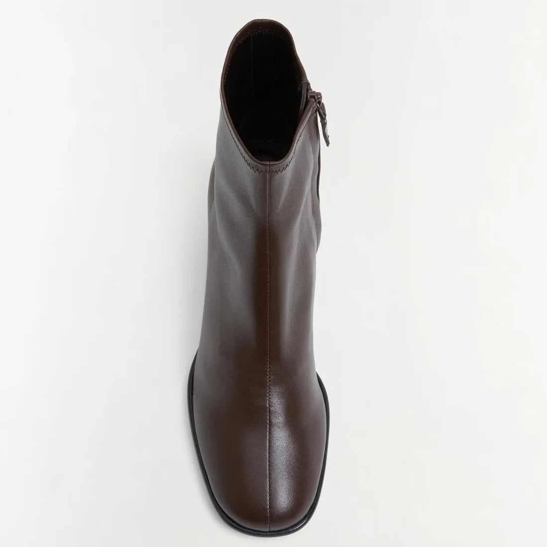The Simkhai Bianca Stretch Leather Ankle Boot, shown in brown from a top-down view against a plain white background, features a block heel, rounded toe, and highlights its side zipper detail.