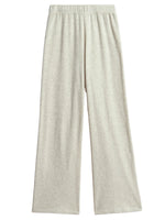 The Suzie Kondi Zephyra Flare Pants are light gray, high-waisted wide leg pants with an elastic waistband, made from soft terry toweling and shown on a flat white background.
