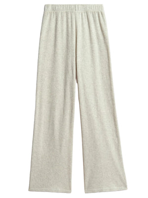 The Suzie Kondi Zephyra Flare Pants are light gray, high-waisted wide leg pants with an elastic waistband, made from soft terry toweling and shown on a flat white background.