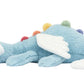 Sky Dragon by Jellycat lounges on its side, white wings outstretched and colorful spikes along its back—a charming midnight companion for mountaintop campers.