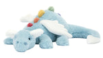 The Jellycat Sky Dragon is a soft blue plush with white wings, a white tail tip, and rainbow bumps along its back, lying flat on its stomach—perfect for late-night storyteller campers.