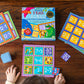 A child’s hands playing Eeboo’s Simple Math Bingo with vibrant cards and tiles displaying addition and subtraction problems on a wooden table, helping to strengthen early math skills.