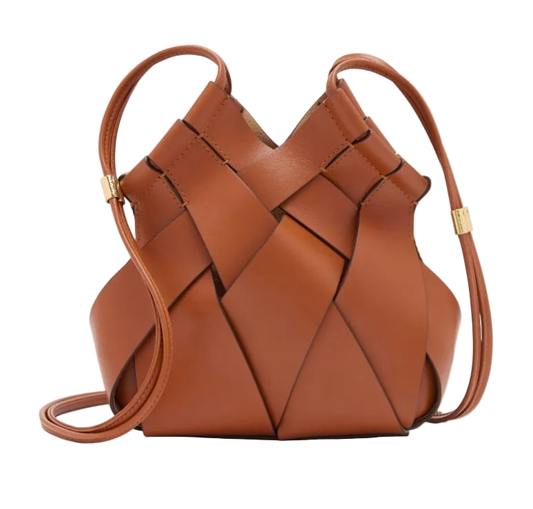 Ulla Johnson's Charlotte Crossbody is a brown calfskin leather bag with a structured, geometric woven design and thin adjustable straps, highlighting artisanal craftsmanship.