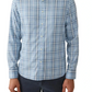 A person wears a Faherty Movement Sport Shirt, featuring a blue and white checkered pattern, made of wrinkle-resistant Supima cotton, paired with dark pants; shown from shoulders to waist.