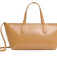 The Mansur Gavriel Mini Everyday handbag blends Italian spazzolato leather with a sleek design, featuring short handles and an adjustable crossbody strap for versatile wear.