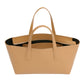 The Mini Everyday by Mansur Gavriel is a tan leather tote crafted from luxurious Italian spazzolato leather, featuring dual handles, a wide opening, and a zippered inner compartment. It also includes an adjustable crossbody strap for versatile carrying options.
