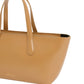 Introducing the Mansur Gavriel Mini Everyday tote bag, crafted from exquisite tan Italian spazzolato leather. It features two handles and a structured design, combining elegance with functionality.