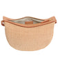 The Moon Sling Raffia Bag by Mansur Gavriel is a woven straw handbag with tan leather trim, gold zipper, an open beige interior, and a chic adjustable strap for versatile crossbody wear.