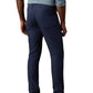 Man wearing a blue checked long-sleeve shirt, Faherty Movement Linen 5-Pocket Pant in navy blue, and brown shoes, shown from the back.
